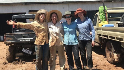 Four happy but muddy surveyors.