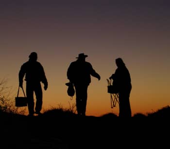 Silhouette of supporters packing up at dusk.