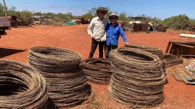 Annie and Ian with coils of removed wire waiting for recycling.
