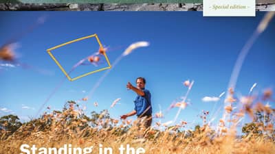 Ecologist Matt Appleby throws a quadrant measure into native grasses on the cover of Bushtracks Winter 2017.