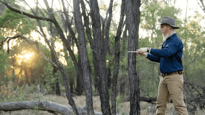 Ecologist Stephen Kearney measures the diameter of a brigalow tree at Goonderoo Reserve on Western Kangoulu Country, QLD. By Grassland Films