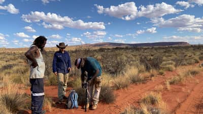 Ivan Wongawol, Jessica Chapman, and Clinton Farmer setting up camera.
