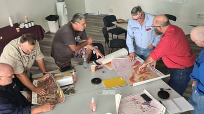 Fire management team consult maps and plan work.