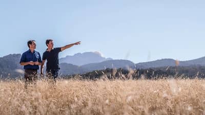 Bush Heritage ecologist Dr Matt Appleby and Midlands farmer Sam Nicolson in a field of native grass.