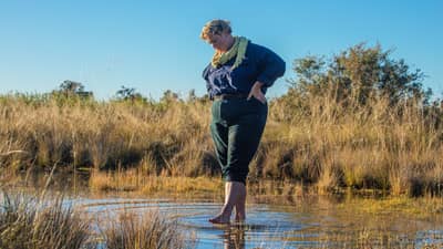 Renee Rossini walks in one of Edgbaston Reserve's artesian springs on Bidjara Country, 140 km north-east of Longreach, QLD. By Calumn Hockey