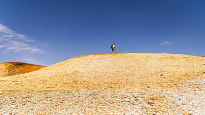 Bush Heritage ecologist Graeme Finlayson walks a top a rocky outcrop at Evelyn Downs Reserve, in the painted desert region of South Australia.
