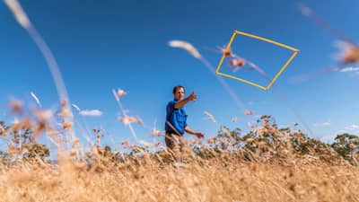 Ecologist Matt Appleby tossing a quadrat to conduct a grassland survey in the Tasmanian Midlands.