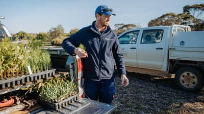 Alex Hams with seedlings for revegetation work.