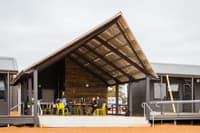 Bush Heritage staff and volunteers sit on the front deck of Michael Tichbon field station at Red Moort Reserve, WA.