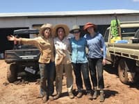 Four happy but muddy surveyors.