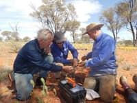 Volunteers Tony Geyer and Tamara Potter help with animal processing.