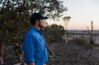 Healthy Landscapes Manager Alex Hams stands looking out over Dodgey Downs at dawn.