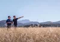 Bush Heritage ecologist Dr Matt Appleby and Midlands farmer Sam Nicolson in a field of native grass.