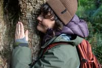 Tiahni Adamson hugs a huge tree in the Liffey Valley, Tasmania.