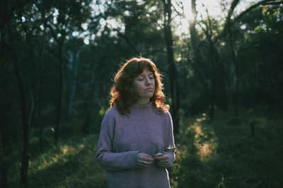 A young woman walking in nature.