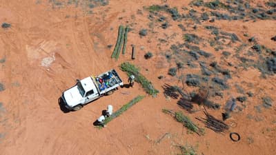 Assembling banks to control water flow as part of landscape rehydration works at Boolcoomatta Reserve.