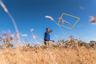 Ecologist Matt Appleby tossing a quadrat to conduct a grassland survey in the Tasmanian Midlands.