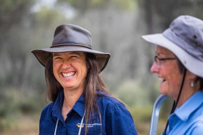 Ecologists Michelle Hall and Angela Sanders share a laugh in the field.