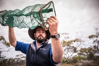 Ecologist Ben Parkhurst checking reptile trap.