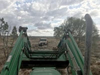 Using tractor to pull the Landcruiser out of the mud.