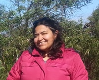 Bush Heritage Regional Quantitative Ecologist Angela Recalde-Salas, a young, brown-skinned woman with shoulder-length black hair.