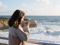 Amy taking a photo of the 12 Apostles, Eastern Maar and Wadawurrung Country, Victoria.