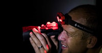Photo Nick Leseberg tests out a night vision scope. Photo Lachlan Gardiner.