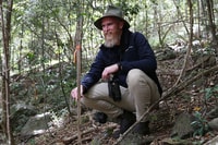 Central Queensland Ecologist Stephen Kearney stands amongst the bright Bottlebrush at Currumbin Valley Reserve, Yugambeh Country, QLD. Photo by Daniella Teixeira