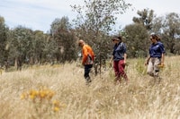 Fire Expert Dean Freeman, Tarcutta Hills Co-Reserve Manager Kelly Price and Aboriginal Partnerships Manager NSW Vikki Parsley inspect the burn area.