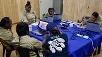 Wunambal Gaambera Rangers inspect satellite images to locate turtle tracks. By Jill Rischbieth
