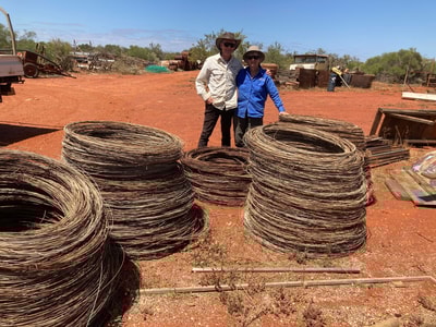 Annie and Ian with coils of removed wire waiting for recycling.