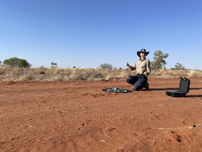 Intern Megan Suthers with a drone on Ethabuka Reserve.