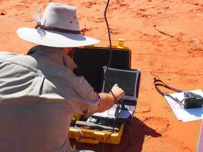 David Nelson from the University of Sydney downloading data from a weather station at Ethabuka Reserve.