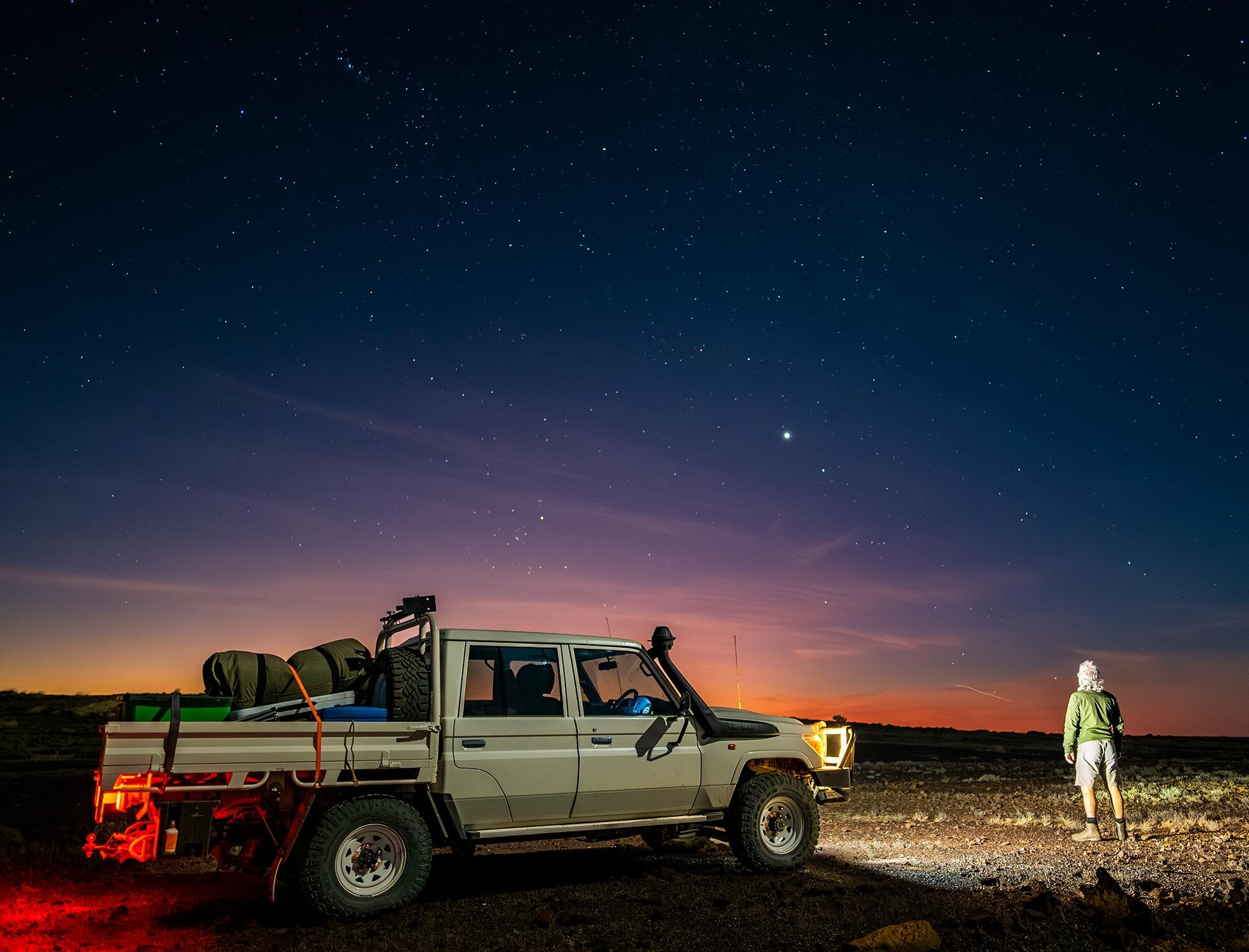 Ute and person searching for Night Parrots in the dark.